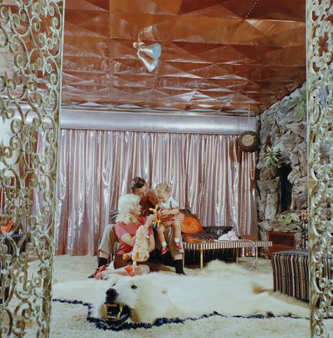 <p>Allan Grant/The LIFE Picture Collection/Shutterstock</p> Jayne Mansfield, Mickey Hargitay, and Miklos Hargitay Jr. in their home known as 'The Pink Palace'.