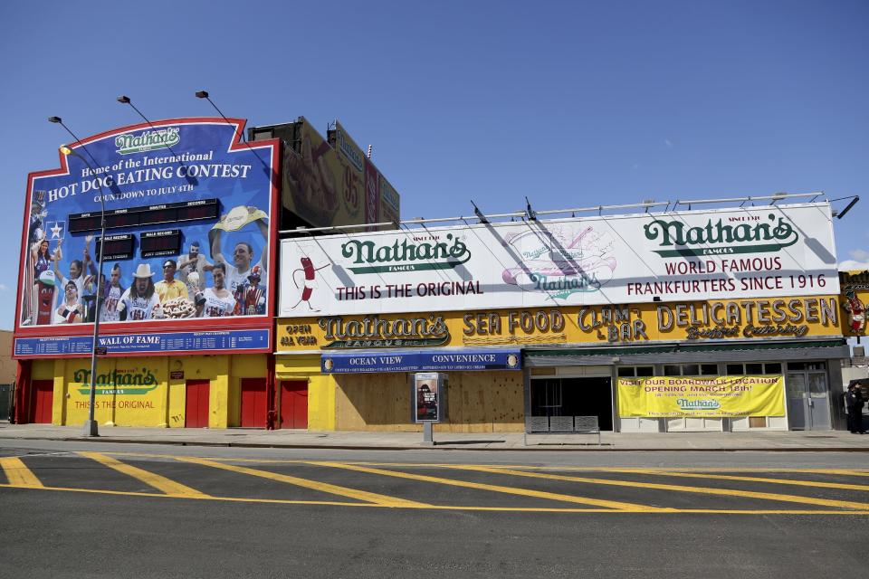 A Saturday March 30, 2013, photo shows the boarded up flagship Nathan's Famous hot dog stand in New York's Coney Island. Despite making the traditional Palm Sunday opening, many of the seasonal businesses at Coney Island are still reeling from the aftermath of Superstorm Sandy. (AP Photo/Mary Altaffer)
