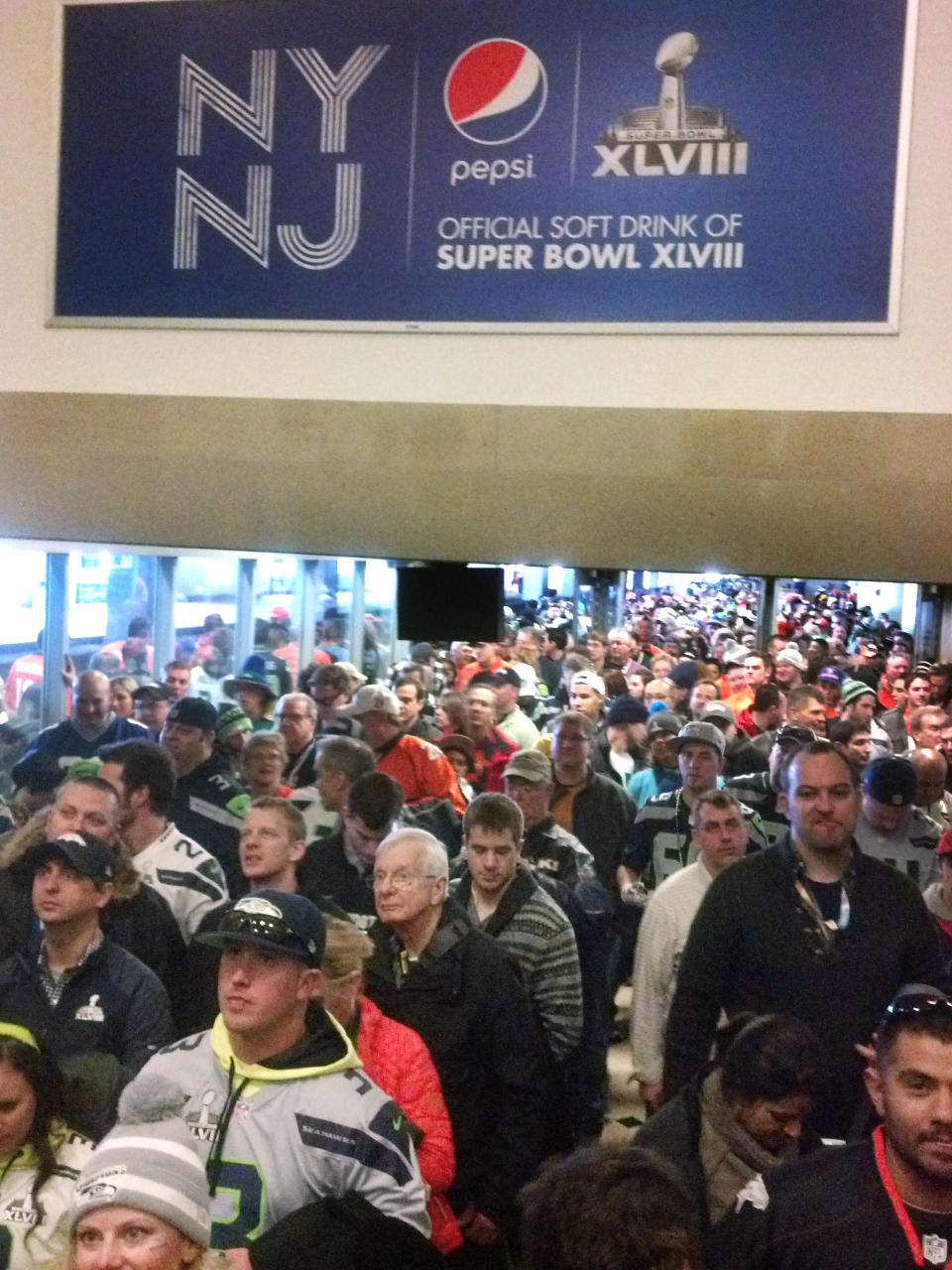 Fans from Manhattan bound for MetLife Stadium and the Super Bowl crowd a NJ Transit station in Secaucus, N.J., Sunday, Feb. 2, 2014. The crowds came to a standstill for a time and began to move again at about 4 p.m. Fans had to go through a security screening at Secaucus before boarding shuttles to the stadium. (AP Photo/Verena Dobnik)