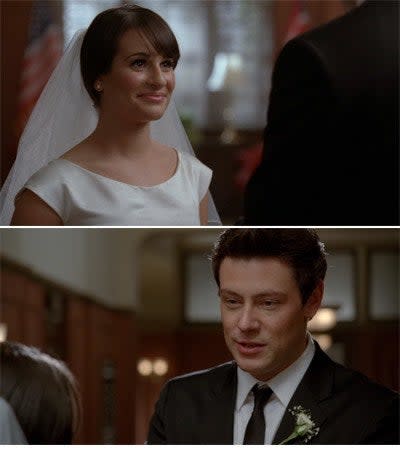 Rachel in a wedding dress looking at Finn in a suit