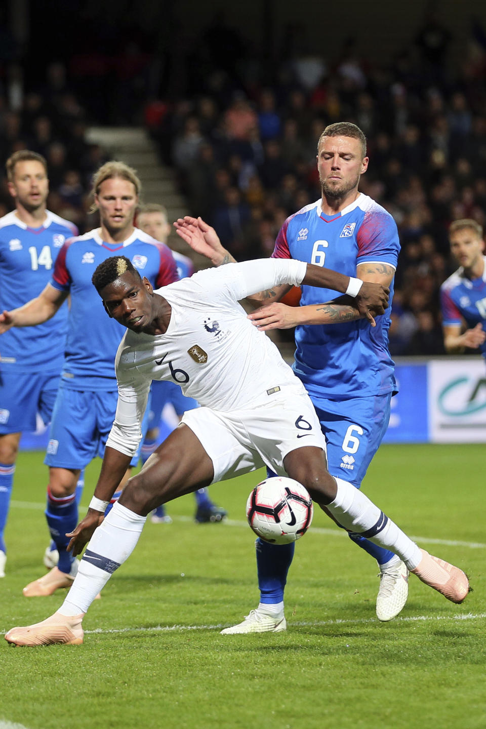 France's Paul Pogba, foreground, challenges for the ball with Iceland's Ragnar Sigurdsson, during a friendly soccer match between France and Iceland, in Guingamp, western France, Thursday, Oct. 11, 2018. (AP Photo/David Vincent)