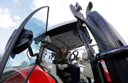 Czech presidential candidate Jiri Drahos sits inside a tractor during a campaign ahead of an election run-off on January 26-27, at a farm near the town of Kamenny Ujezd, Czech Republic January 19, 2018. REUTERS/David W Cerny/Files