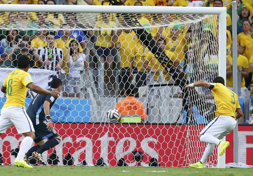 Brazil's Thiago Silva (R) scores against Colombia during their 2014 World Cup quarter-finals at the Castelao arena in Fortaleza July 4, 2014. REUTERS/Yves Herman