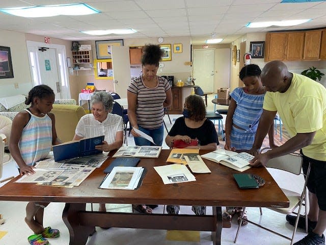 Black History Committee members Suzanne Hale and Shirley Davidson (seated) and Ronnie Pepper meeting with youngsters at A Place to Go Center.