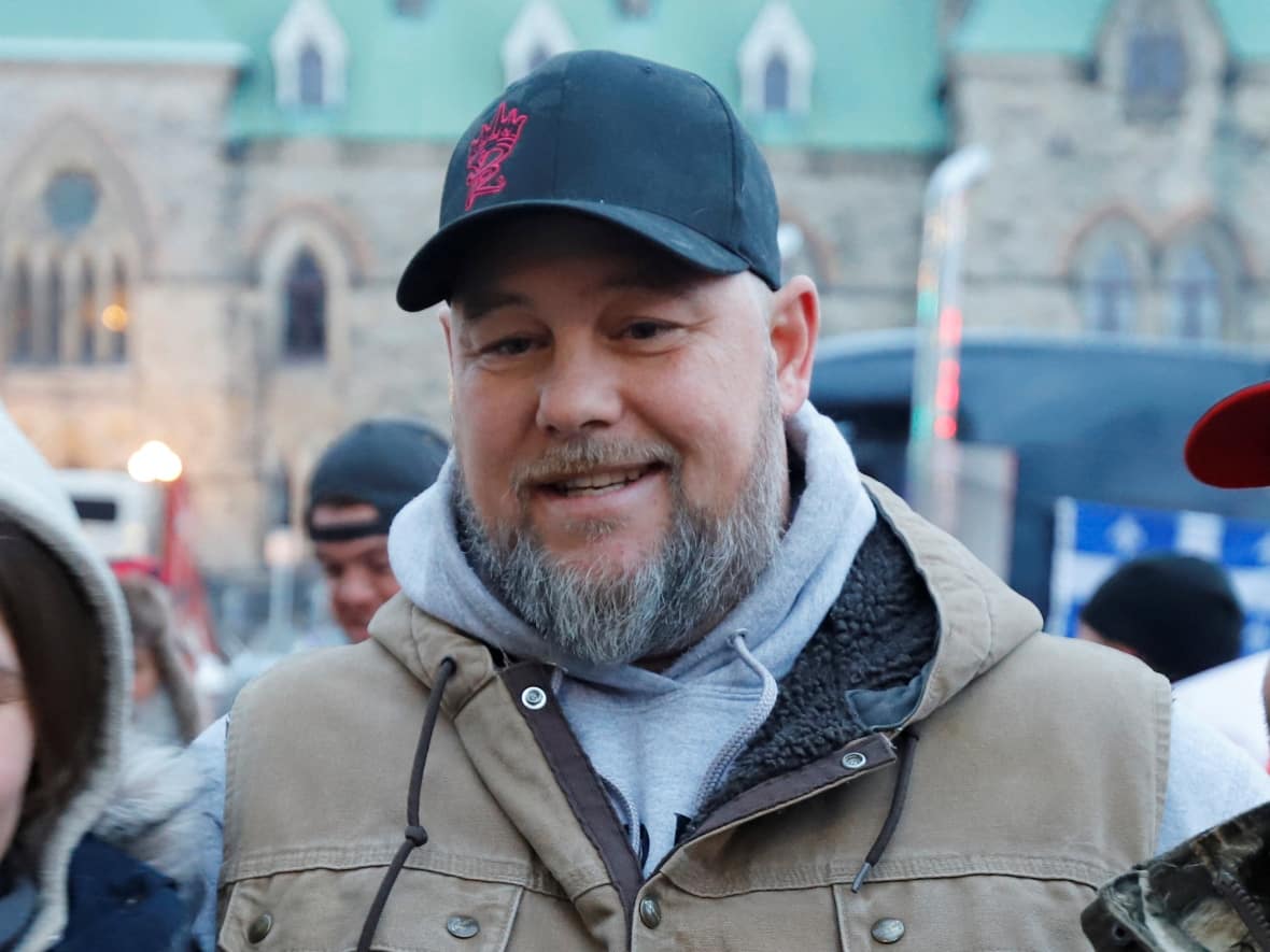 Pat King, one of the organizers of the protest, poses for photos in front of Parliament Hill as truckers and their supporters continue to protest against COVID vaccine mandates in Ottawa on Feb. 16, 2022. King is currently in jail facing charges for his role in the Freedom Convoy protests. (Patrick Doyle/Reuters - image credit)