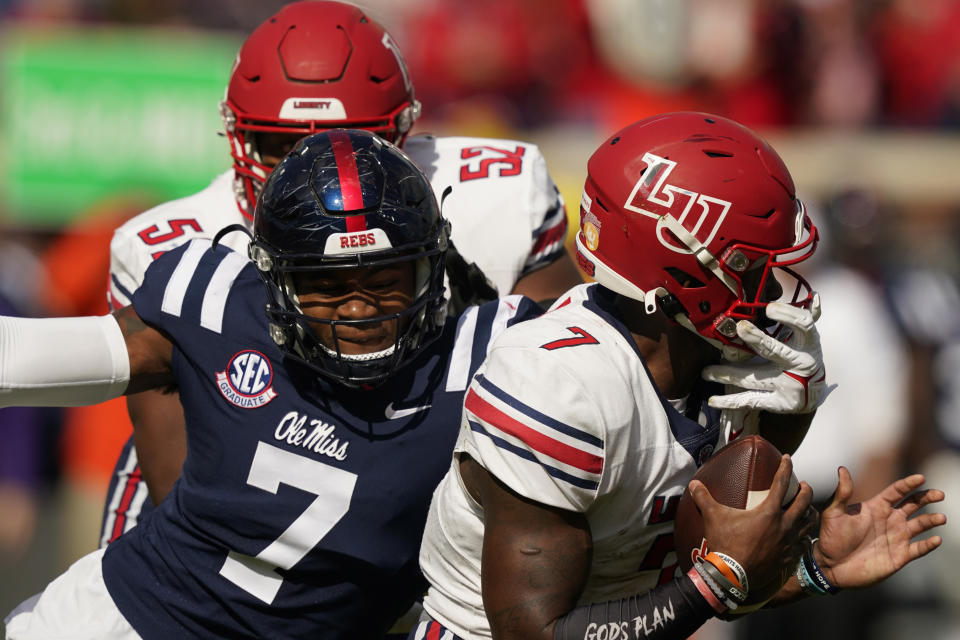 Liberty quarterback Malik Willis (7) is tackled for a loss by Mississippi defensive lineman Sam Williams (7) during the first half of an NCAA college football game in Oxford, Miss., Saturday, Nov. 6, 2021. (AP Photo/Rogelio V. Solis)