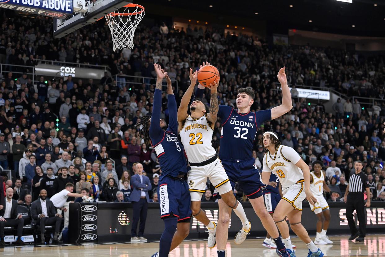 Providence guard Devin Carter shoots against Connecticut defenders during the game on March 9 at Amica Mutual Pavilion.