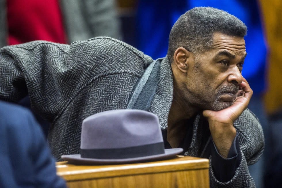 Flint City Councilman Eric Mays, 1st Ward, kneels at the front of the gallery to hear Genesee District Judge William Crawford read through a prepared statement during a hearing, Dec. 7, 2018, at Genesee District Court in downtown Flint, Mich. (Jake May/The Flint Journal via AP, file)