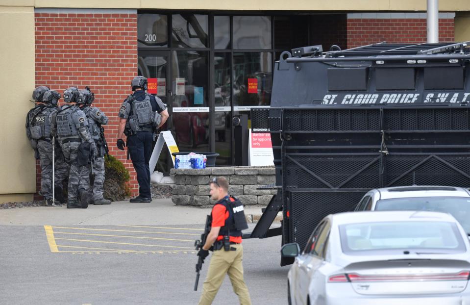 <p>Officers stand near an entrance to the Wells Fargo branch Thursday May 6, 2021, in south St. Cloud, Minn. following a reported hostage situation. Police in Minnesota were on the scene Thursday of a reported bank robbery with hostages. </p> ((Dave Schwarz/St. Cloud Times via AP))