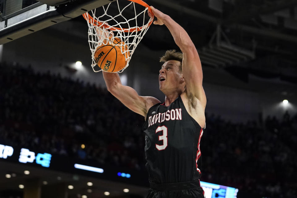 Davidson's Sam Mennenga (3) shoots and scores during the first half of a college basketball game in the first round of the NCAA tournament Michigan State, Friday, March 18, 2022, in Greenville, S.C. (AP Photo/Brynn Anderson)