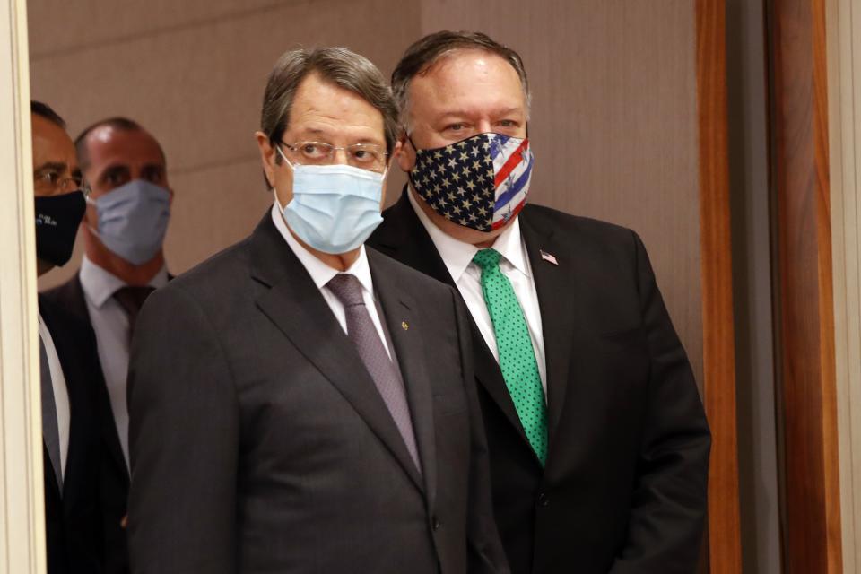 U.S. Secretary of State Mike Pompeo, right, Cypriot President Nicos Anastasiades arrive for a press conference at the Presidential Palace in Nicosia, Cyprus, Saturday, Sept. 12, 2020. Pompeo's lightning visit to Cyprus aimed to de-escalate a confrontation between Greece and Turkey over energy reserves in east Mediterranean waters and to affirm Washington's continued engagement in the tumultuous region four days after Russian Foreign Minister Sergey Lavrov pitched Moscow's offer to help ease tensions during his trip to the island nation. (AP Photo/Petros Karadjias, Pool)