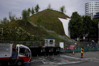 The newly built "Marble Arch Mound" after it was opened to the public next to Marble Arch in London, Tuesday, July 27, 2021. The temporary installation commissioned by Westminster Council and designed by architects MVRDV has been opened as a visitor attraction to try and entice shoppers back to the adjacent Oxford Street after the coronavirus lockdowns. (AP Photo/Matt Dunham)