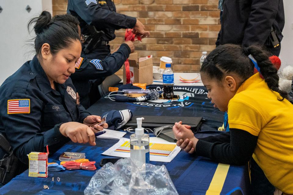 The Paterson Police Department is using a grant to give gift cards to families at the Center City Mall in Paterson, NJ on Wednesday, Dec. 21, 2022. Detective Cindy Carrera talks with Naedih Rivera.