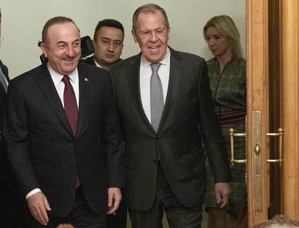 Turkish Foreign Minister Mevlut Cavusoglu, left, and Russian Foreign Minister Sergey Lavrov enter a hall for the talks in Moscow, Russia, Monday, Jan. 13, 2020.Foreign and defense ministers of Russia and Turkey met as part of an effort by Moscow and Ankara to sponsor Monday's talks between rival parties in Libya in the Russian capital. (AP Photo/Pavel Golovkin, Pool)