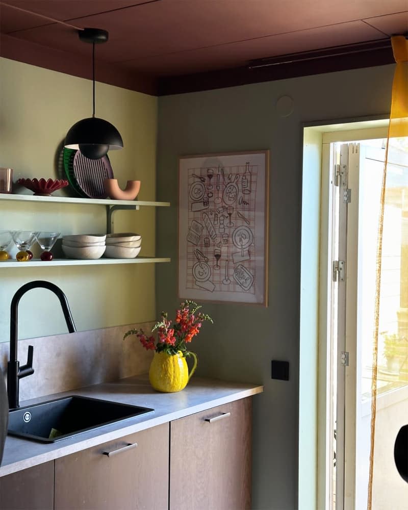 A black mushroom pendant above the kitchen sink.