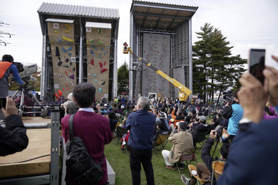 People watch the women's and men's lead semi-final of the IFSC Climbing World Cup Friday, Oct. 21, 2022, in Morioka, Iwate Prefecture, Japan. After Iranian climber Elnaz Rekabi joined a growing list of female athletes who have been targeted by their governments for defying authoritarian policies or acting out against bullying, a number of others have spoken out on their concerns of politics crossing into their sporting world. (AP Photo/Eugene Hoshiko)