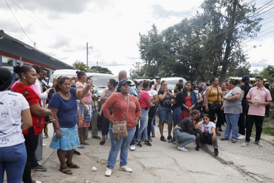 Familiares esperan en la entrada de la cárcel de mujeres de Tamara, a las afueras de Tegucigalpa, Honduras, el martes 20 de junio de 2023. Un motín en el centro penitenciario de mujeres del noroeste de la capital hondureña dejó al menos 41 reclusas muertas, en su mayoría quemadas, afirmó un oficial de la Policía de Honduras. (AP Foto/Elmer Martínez)