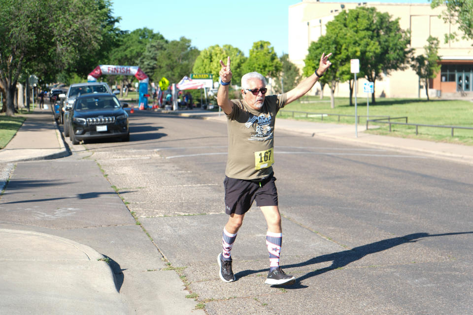 A runner celebrates at the Chief Petty Officer Jack R. Barnes Run For the Fallen Saturday morning at Stephen F Austin Park in Amarillo.