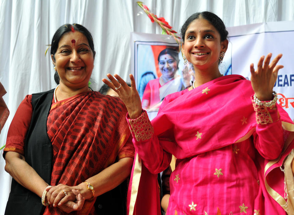 Geeta expresses herself through gestures as Sushma Swaraj looks on at Indore Deaf Bilingual Academy (IDBA) on November 23, 2015. (Photo by Shankar Mourya/Hindustan Times via Getty Images)