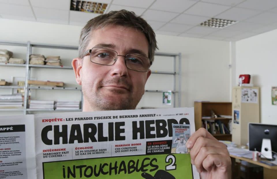 Publishing director of the satyric weekly Charlie Hebdo, Charb, displays the front page of the newspaper as he poses for photographers in Paris, Wednesday, Sept. 19, 2012. Charb was among the people killed in the shooting attack at satirical French magazine Charlie Hebdo in Paris. Photo:AP/Michel Euler