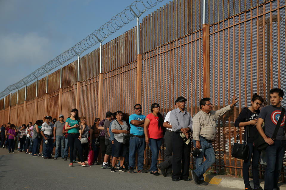 Pedestrian travelers wait in a line at the U.S. port of entry in Hidalgo, Texas. (Photo: Loren Elliott/Reuters)