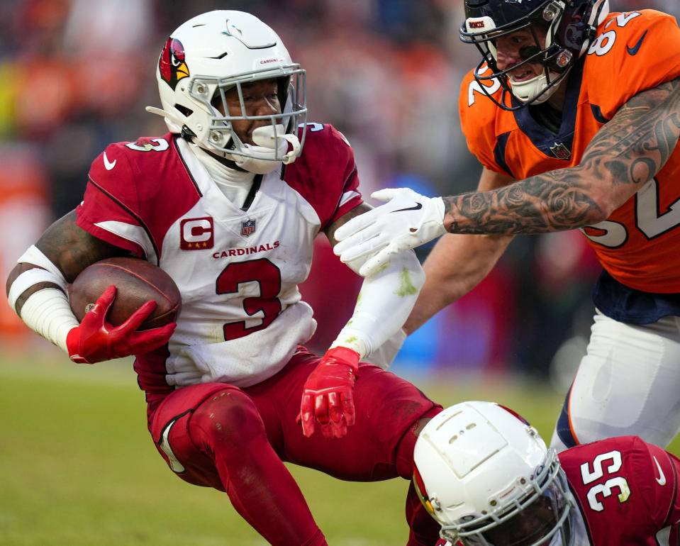 FILE - Arizona Cardinals safety Budda Baker (3) intercepts a pass against Denver Broncos tight end Eric Saubert (82) during the second half of an NFL football game Dec. 18, 2022, in Denver. Baker was one of the rare bright spots on Arizona last season when he earned his fifth Pro Bowl berth in six seasons, (AP Photo/Jack Dempsey, File)