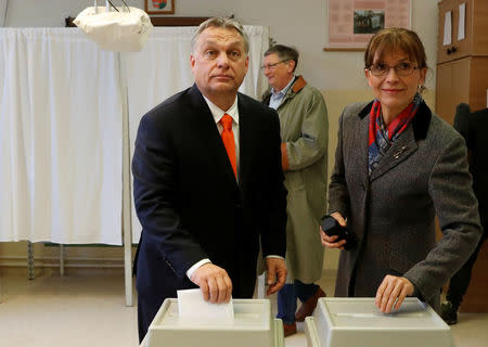 Current Hungarian Prime Minister Viktor Orban and his wife Aniko Levai cast their ballots during Hungarian parliamentary election in Budapest, Hungary, April 8, 2018. REUTERS/Bernadett Szabo