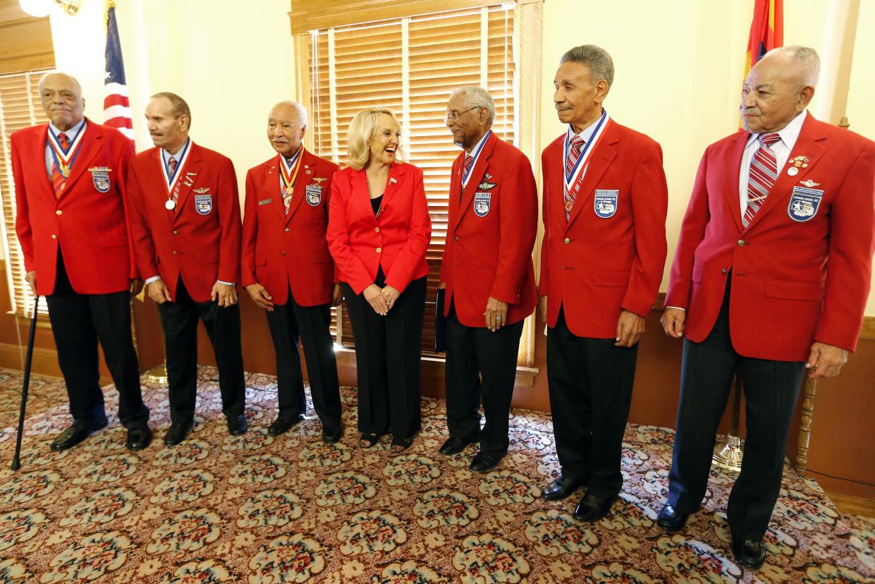 Former Arizona Gov. Jan Brewer stands with former members of the famed Tuskegee Airmen, including George W. Biggs on the far right, at an event in 2013.