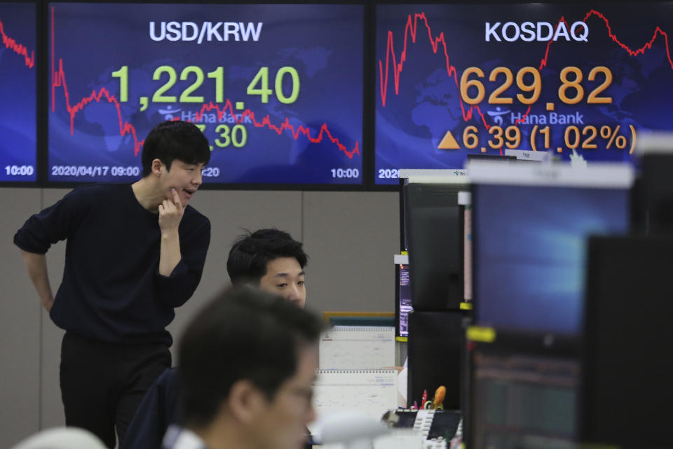 A currency trader watches monitors at the foreign exchange dealing room of the KEB Hana Bank headquarters in Seoul, South Korea, Friday, April 17, 2020. Shares have advanced in Asia after China's economic growth data, while bleak, was better than expected. (AP Photo/Ahn Young-joon)