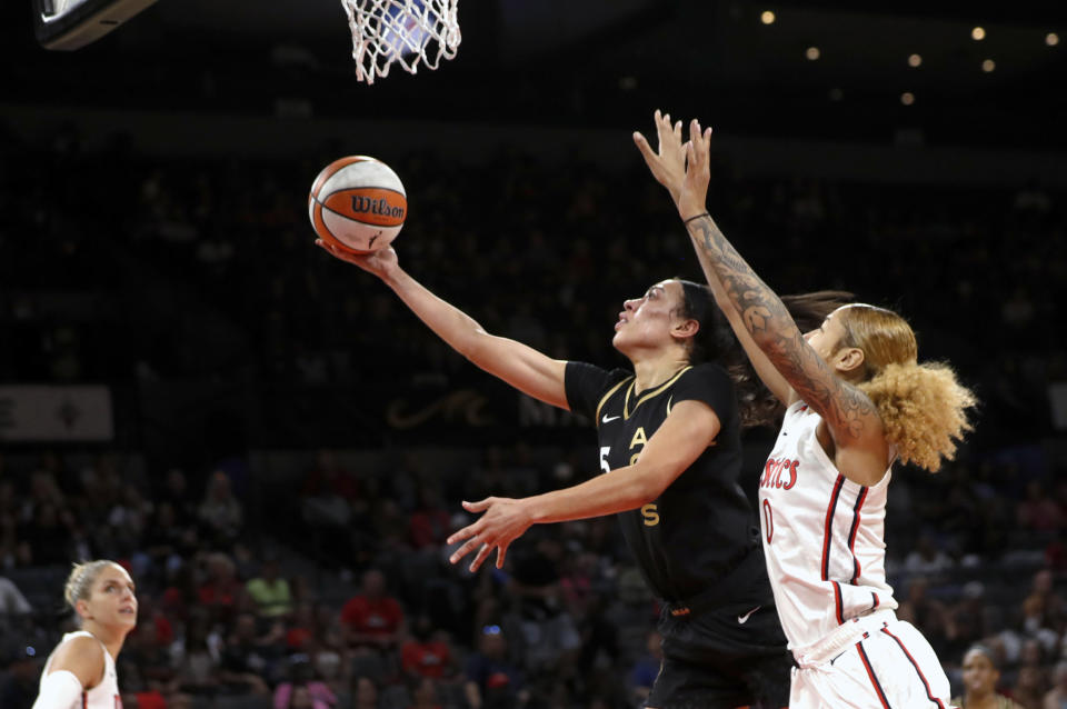 Las Vegas Aces forward Dearica Hamby (5) lays up the ball next to Washington Mystics center Shakira Austin (0) during the first half of a WNBA basketball game Saturday, June 25, 2022, in Las Vegas. (Steve Marcus/Las Vegas Sun via AP)