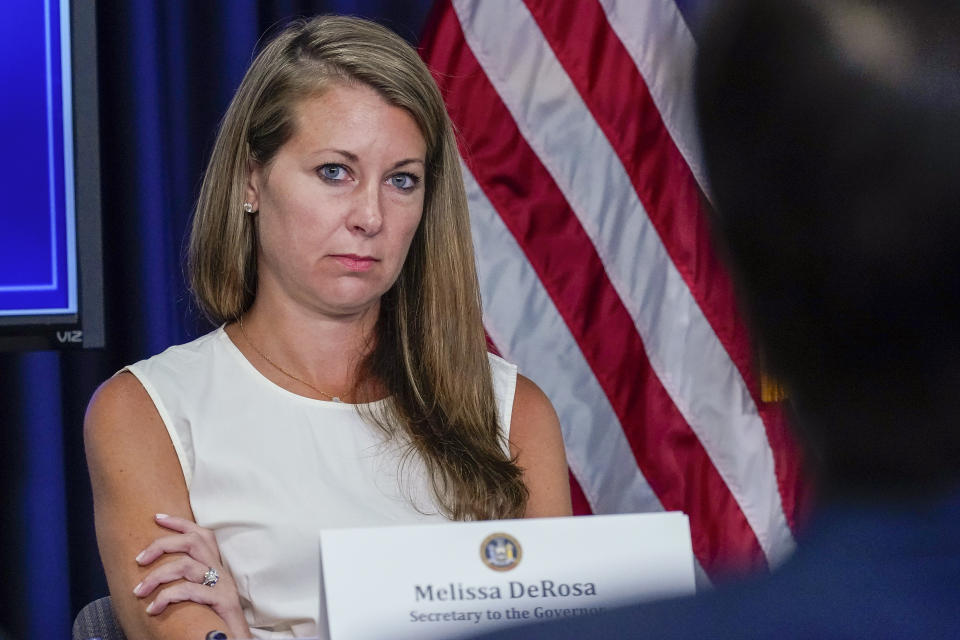 FILE - Secretary to the Governor Melissa DeRosa listens as New York Gov. Andrew Cuomo speaks to reporters during a news conference, Wednesday, June 23, 2021, in New York. DeRosa resigned Sunday, Aug. 8 a week after a report found the governor sexually harassed 11 women. (AP Photo/Mary Altaffer, File)