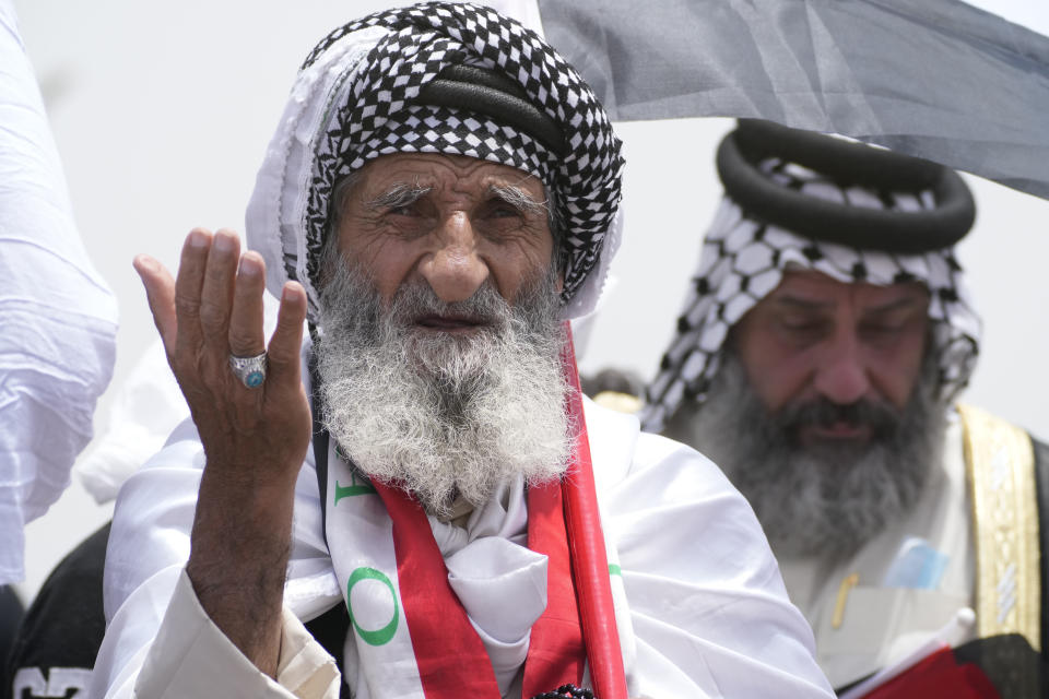 A man attends an open-air Friday prayers in Sadr City, Baghdad, Iraq, Friday, July 15, 2022. (AP Photo/Hadi Mizban)