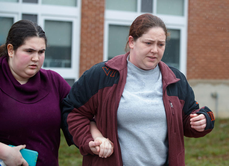 <p>A mother walks her daughter, a student from Great Mills High School, to the car as she picks her up from Leonardtown High School in Leonardtown, Md., Tuesday, March 20, 2018. (Photo: Carolyn Kaster/AP) </p>