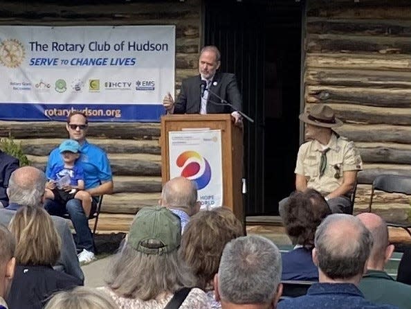 A highlight for the Rotary Club of Hudson was the restoration of the Historic Log Cabin. Pictured is Council President Chris Foster, speaking during the August rededication.