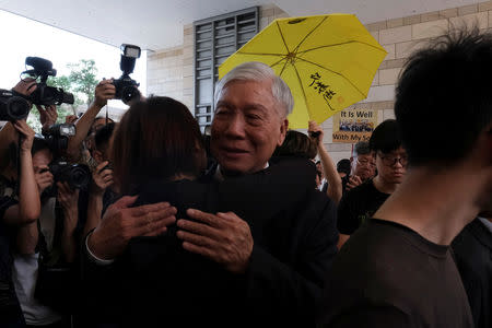 Occupy Central pro-democracy movement founder Chu Yiu-ming hugs a supporter after he had his suspended sentence on his involvement in the Occupy Central, also known as "Umbrella Movement", in Hong Kong, China April 24, 2019. REUTERS/Tyrone Siu