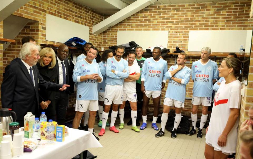 French President Emmanuel Macron and wife Brigitte Macron in the locker room before participating in the charity football match at the LÈo-Lagrange stadium in Poissy, France, on October 14, 2021 - Credit: AP