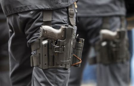 A Heckler & Koch P30 handgun is seen strapped to the leg of a German police officer in Munich in this February 2, 2013 file photo. REUTERS/Michaela Rehle/Files