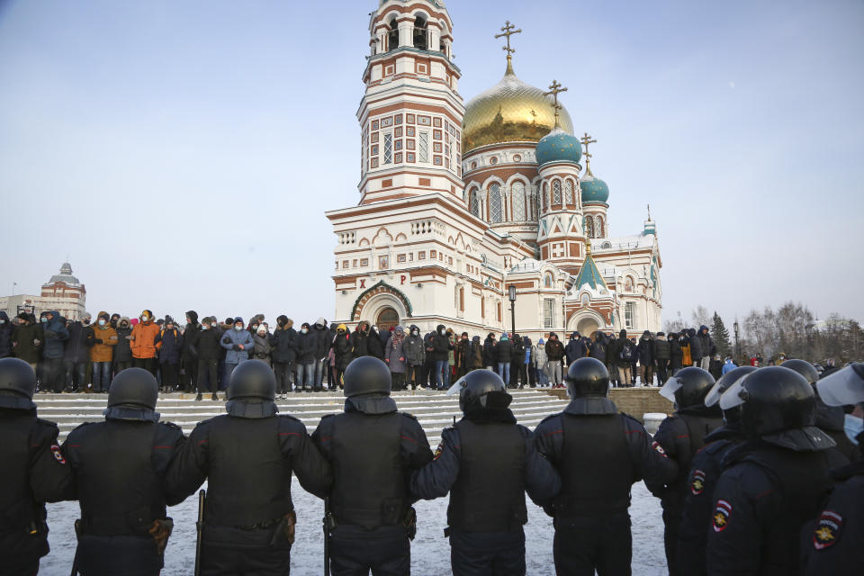 Police stand guard during a protest against the jailing of opposition leader Alexei Navalny in Siberian city of Omsk, Russia, Saturday, Jan. 23, 2021. Russian police on Saturday arrested hundreds of protesters who took to the streets in temperatures as low as minus-50 C (minus-58 F) to demand the release of Alexei Navalny, the country's top opposition figure. Navalny, President Vladimir Putin's most prominent foe, was arrested on Jan. 17 when he returned to Moscow from Germany, where he had spent five months recovering from a severe nerve-agent poisoning that he blames on the Kremlin. (AP Photo)