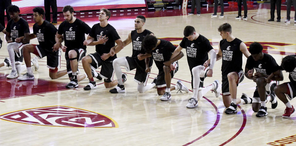 Washington State players take a knee during the national anthem before an NCAA college basketball game against Southern California in Los Angeles on Saturday, Jan. 16, 2021. (Keith Birmingham/The Orange County Register via AP)