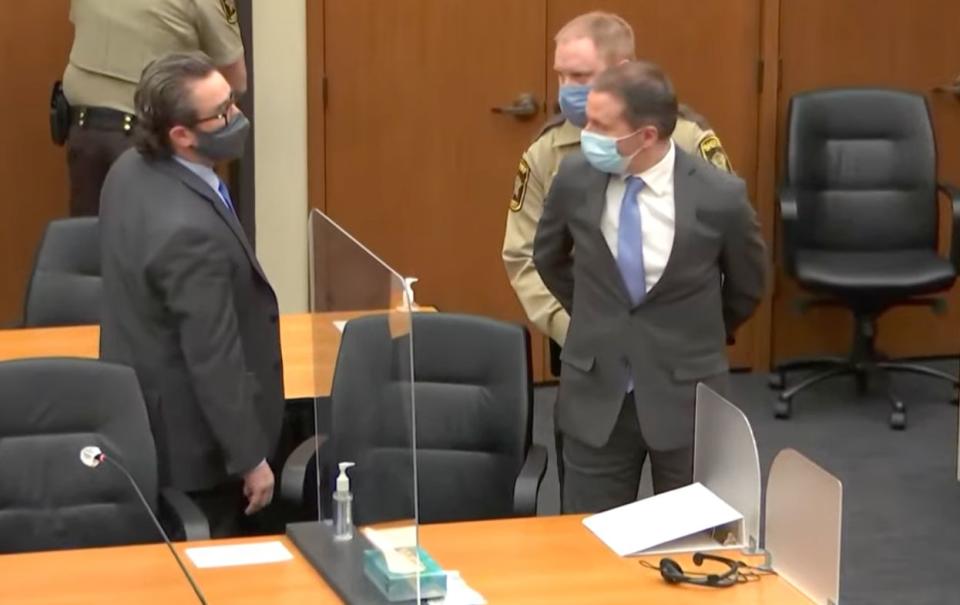 Defense attorney Eric Nelson (left) looks on as Derek Chauvin (right) is taken into custody Tuesday after the verdicts were read by the judge. (Photo: Hennepin County)