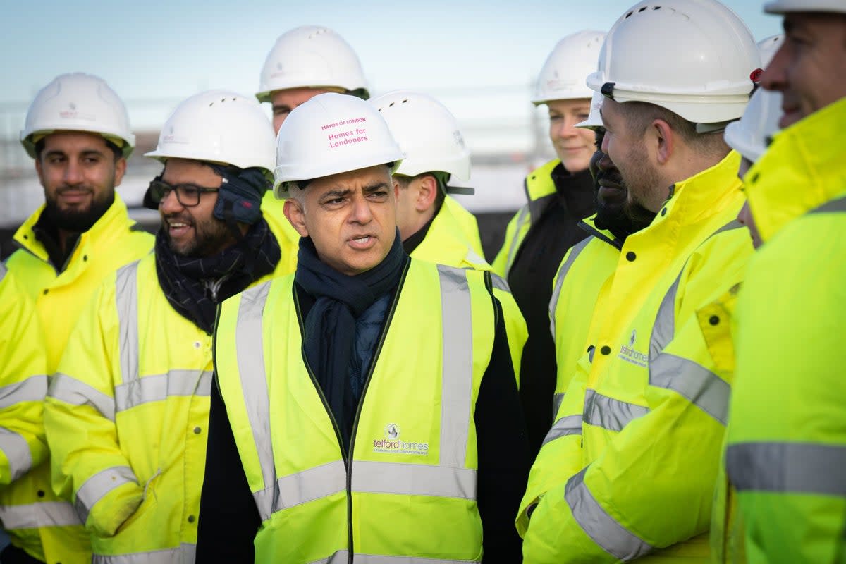 Mayor of London Sadiq Khan (centre) during the topping out ceremony of a new affordable housing development in the Royal Docks last year (PA)