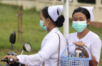 FILE - In this July 25, 2017 file photo, nurses cover their faces with masks to protect from the spread of the swine flu outside the Naypyitaw hospital in Naypyitaw, Myanmar. On Tuesday, March 10, 2020, the U.S. Centers for Disease Control and Prevention posted guidance to doctors and nurses that surgical masks are OK to wear when treating patients who may be sick from the new coronavirus — a decision made in reaction to possible shortages of a more protective respirator masks. (AP Photo/Aung Shine Oo)