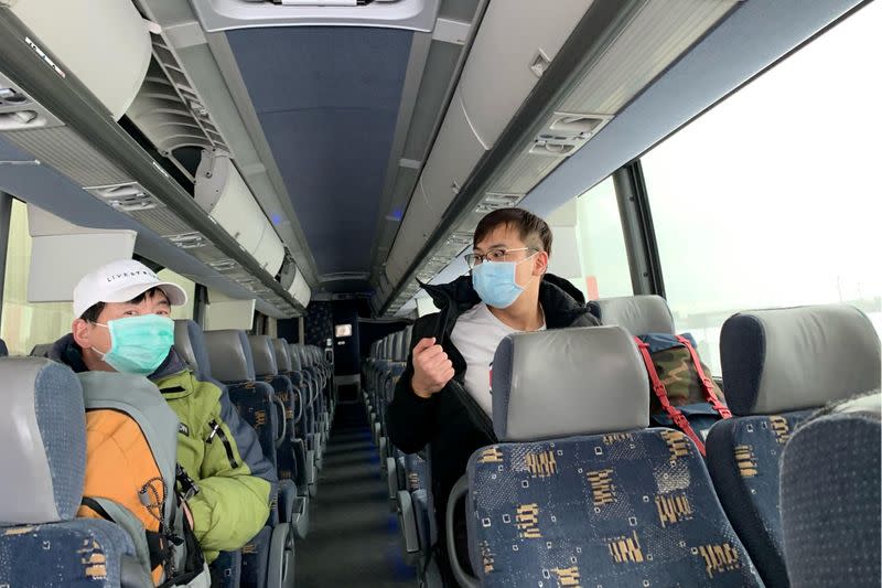 FILE PHOTO: Evacuated Canadians board a bus in Trenton