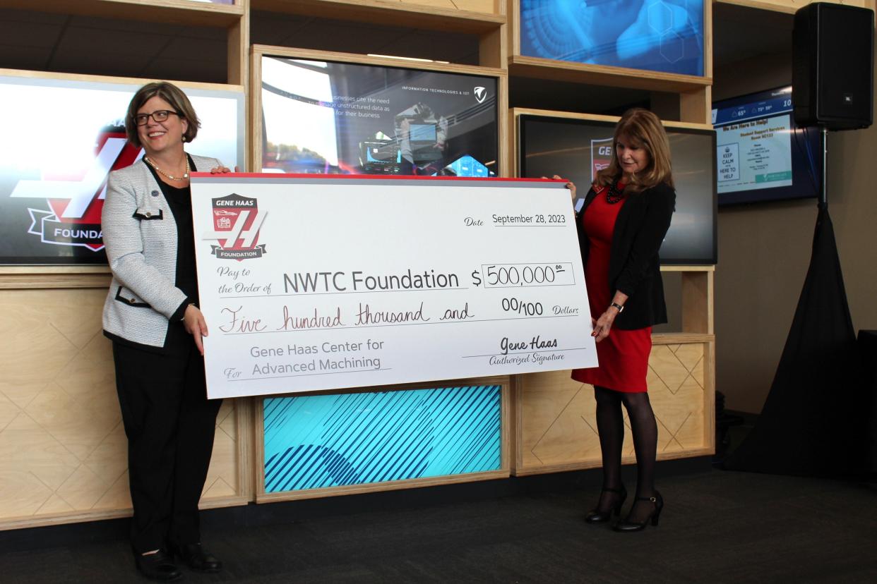 Northeast Wisconsin Technical College President Kristen Raney and Kathy Looman, the director of education grants at the Gene Haas Foundation, pose with a $500,000 check from the foundation to NWTC on September 28, 2023 in Green Bay.
