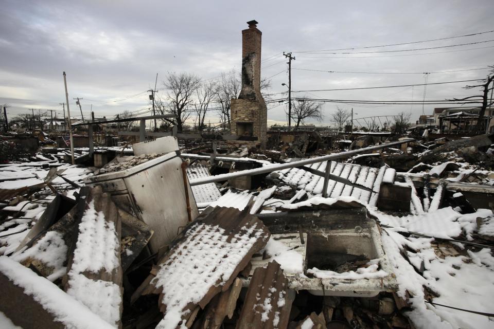 A fire-scorched landscape of Breezy Point is shown after a Nor'easter snow, Thursday, Nov. 8, 2012 in New York.  The beachfront neighborhood was devastated during Superstorm Sandy when a fire pushed by the raging winds destroyed many homes.  (AP Photo/Mark Lennihan)