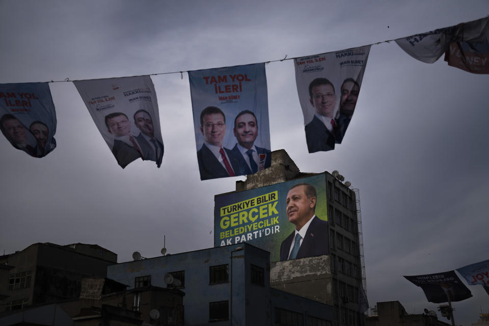 Banners of Turkish President and leader of the Justice and Development Party, or AKP, Recep Tayyip Erdogan, bottom, and Republican People's Party, or CHP, Ekrem Imamoglu hung ahead of nationwide municipality elections, in Istanbul, Turkey, Sunday, March 24, 2024. On Sunday, millions of voters in Turkey head to the polls to elect mayors and administrators in local elections which will gauge President Recep Tayyip Erdogan’s popularity as his ruling party tries to win back key cities it lost five years ago.(AP Photo/Francisco Seco)