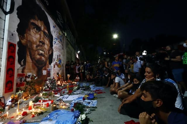 Fans hold a vigil for Diego Maradona outside the stadium of Argentinos Juniors 