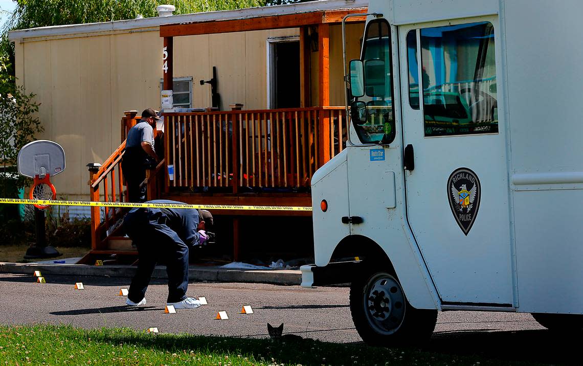 Richland Police investigators document the scene of Wednesday’s morning fatal stabbing in the 50 block of Cosmic Lane in north Richland.