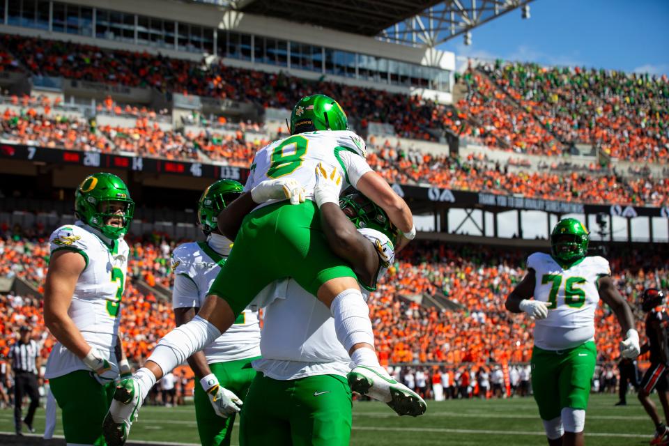 Oregon quarterback Dillon Gabriel is hoisted into the air after rushing for a touchdown as the Oregon State Beavers host the Oregon Ducks Saturday at Reser Stadium in Corvallis.