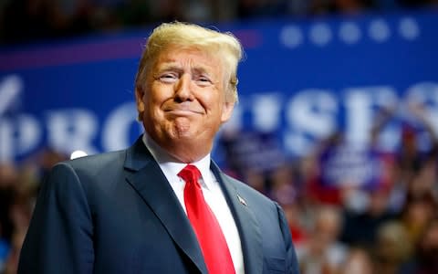 President Donald Trump looks to the cheering crowd as he arrives to speak at a rally at Allen County War Memorial Coliseum, Monday, Nov. 5, 2018, in Fort Wayne - Credit:  Carolyn Kaster/AP